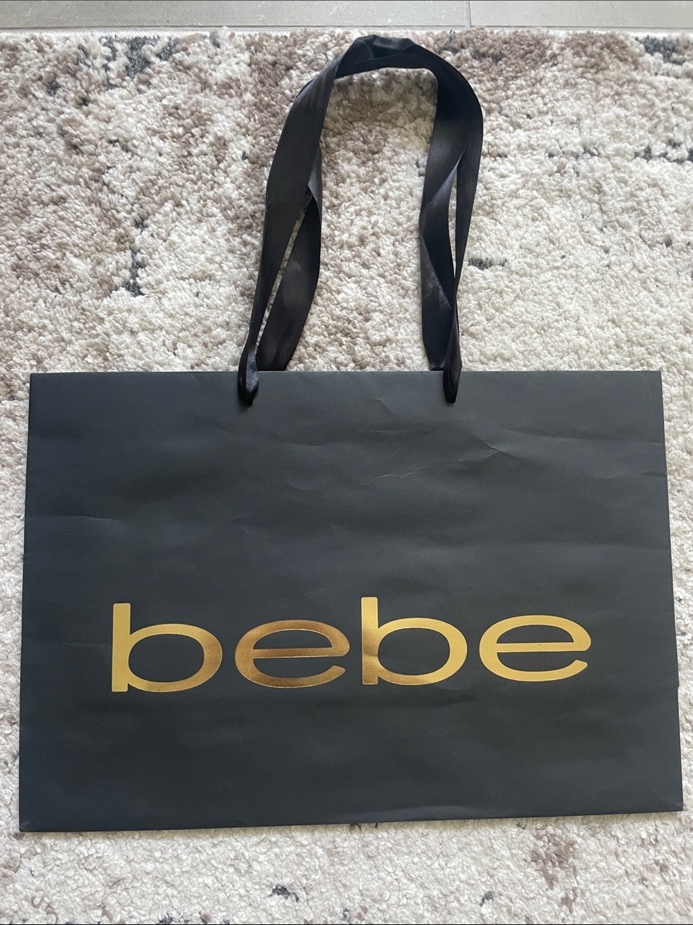 bebe Black Tote with Gold Logo and Ribbon Handles. 16 inches X 11 Inches